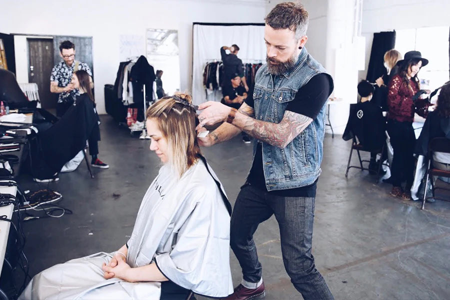 Andrew Carruthers combing client's hair